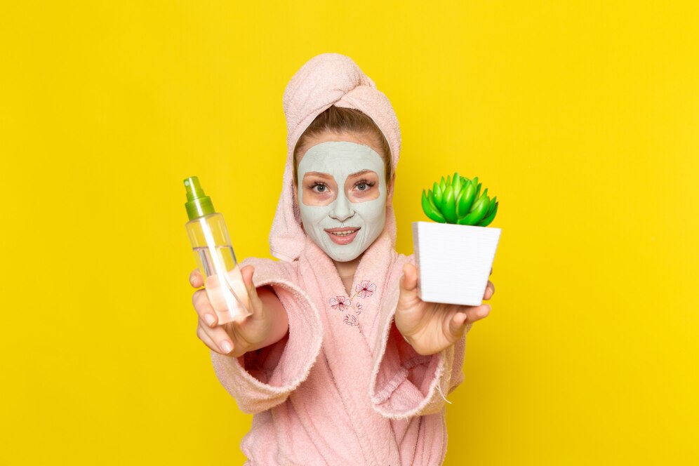 front-view-young-beautiful-female-pink-bathrobe-holding-spray-little-green-plant_140725-17142 راهکارهای پوست مختلط: پوستی شاداب و یکدست با روتین مناسب